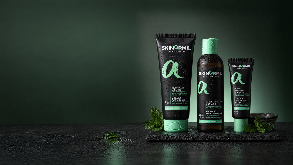 Skinormil Anti-Acne purifying gel, purifying lotion and skin balance cream on wet slate